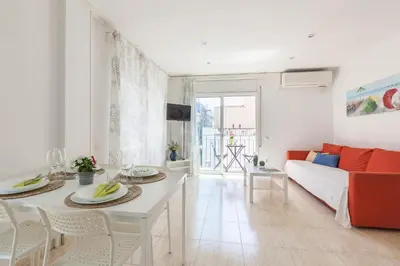 a living room with a couch and a table at Nova Apartment by Hello Homes Sitges in Sitges