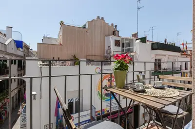 a balcony with a table and a vase of flowers at Nova Apartment by Hello Homes Sitges in Sitges