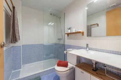 a bathroom with a shower and a toilet and a sink at SOUL by Hello Homes Sitges in Sitges