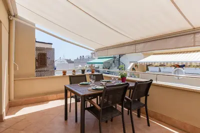 a dining room with a table and chairs on a balcony at SOUL by Hello Homes Sitges in Sitges