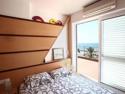 a bedroom with a bed and a large window at Sitges Views in Sitges