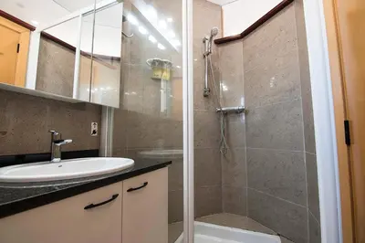a bathroom with a sink and a glass shower at Sitges Views in Sitges