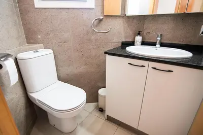 a bathroom with a toilet and a sink at Sitges Views in Sitges