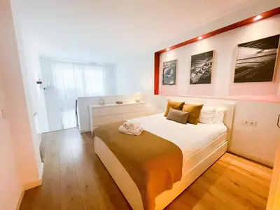a bedroom with a large white bed in a room at Boutique Llobregat in Hospitalet de Llobregat