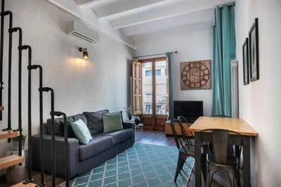 a living room with a couch and a table at Beautiful renovated Loft minutes from the beach in Barcelona