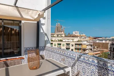 a balcony with a table and a view of a city at Sagrada Familia Apartment by Olala Homes in Barcelona