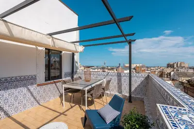 a patio with a table and chairs on a balcony at Sagrada Familia Apartment by Olala Homes in Barcelona