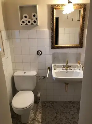 a bathroom with a toilet and a sink at Ca la Trini - turisme rural in Torrellas de Foix