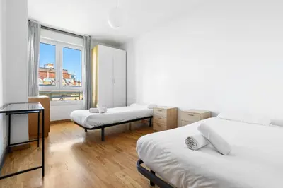 a bedroom with two beds and a window at Families & Groups 4BR2BA by Sagrada in Barcelona