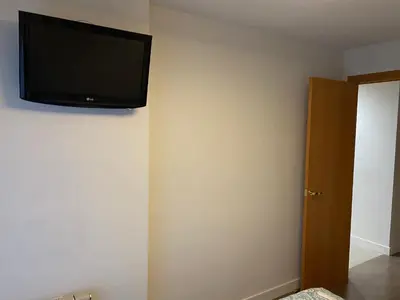 a flat screen tv hanging on a wall at Apartament Sant Jordi in Sant Joan de Vilatorrada