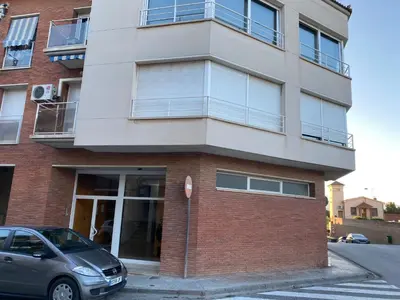 a building with a car parked in front of it at Apartament Sant Jordi in Sant Joan de Vilatorrada