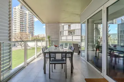 a dining room with a table and chairs on a balcony at Canela Homes BARCELONA DIAGONAL MAR in Barcelona