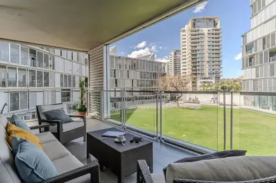 a living room with a couch and chairs and a large window at Canela Homes BARCELONA DIAGONAL MAR in Barcelona