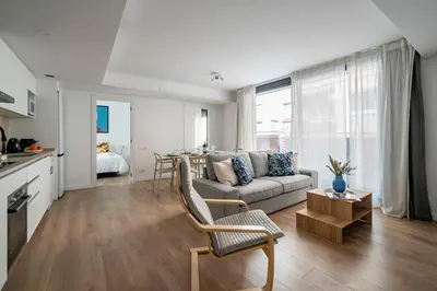 a living room with a couch and a table at Habitat Apartments Teatre in Hospitalet de Llobregat