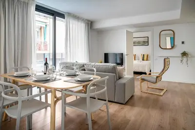 a living room with a table and a couch at Habitat Apartments Teatre in Hospitalet de Llobregat
