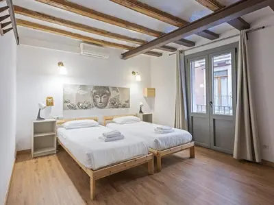 a white bedroom with a large bed and a window at Las Ramblas, comfort in BCN for 8 persons in Barcelona