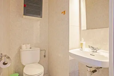 a bathroom with a toilet and a sink at Heaven With a Garden at Las Ramblas in Barcelona