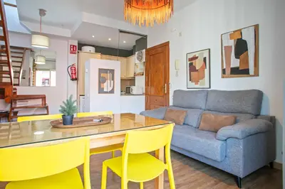 a living room with a couch and a table and chairs at Heaven With a Garden at Las Ramblas in Barcelona
