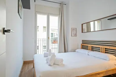 a bedroom with a bed with two teddy bears on it at Heaven With a Garden at Las Ramblas in Barcelona