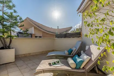 a patio with a chair and a table on a balcony at Canela Homes BARCELONA OLYMPIC in Barcelona