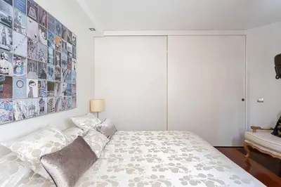 a bedroom with a bed with a large poster on the wall at Canela Homes BARCELONA OLYMPIC in Barcelona