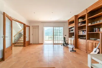 a home office with a desk and bookshelves at Large 5-Bed Villa, mountain and beach, at 30' from Barcelona & 10' from F1 Circuit in Vallromanas