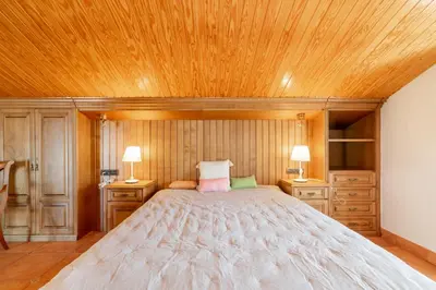 a bedroom with a large bed and wooden ceilings at Large 5-Bed Villa, mountain and beach, at 30' from Barcelona & 10' from F1 Circuit in Vallromanas