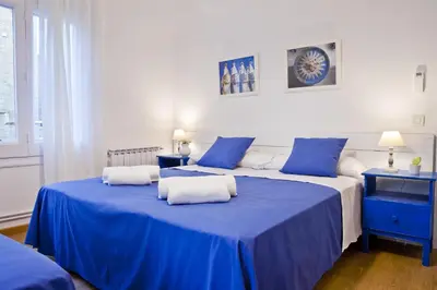two beds in a room with blue and white at Blue Barcelona in Barcelona