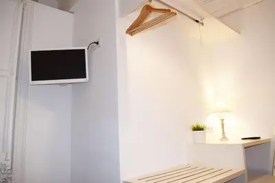 a tv hanging on a wall in a room at Blue Barcelona in Barcelona
