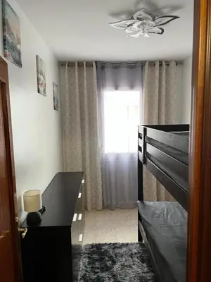 a bedroom with a bed and a window at Logement avec vue latérale mer in Pineda de Mar