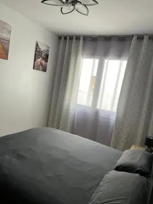 a bedroom with a bed and a window at Logement avec vue latérale mer in Pineda de Mar