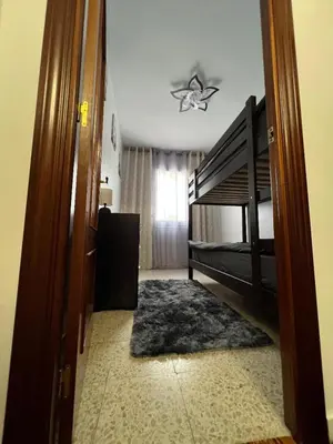 an open door to a bedroom with a bunk bed at Logement avec vue latérale mer in Pineda de Mar