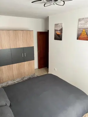 a bedroom with a bed and a ceiling fan at Logement avec vue latérale mer in Pineda de Mar