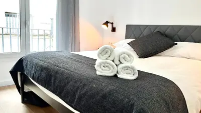 a bedroom with a bed with towels on it at Centro con terraza blco by Prestigi in Terrassa