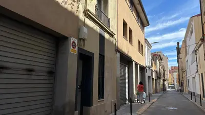 a woman walking down a street next to a building at Centro con terraza blco by Prestigi in Terrassa