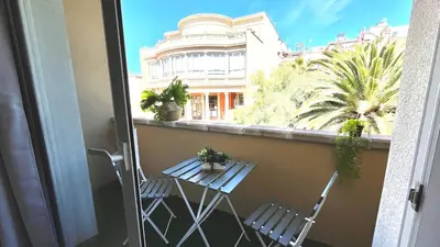 a balcony with two chairs and a table with plants at Centro con terraza blco by Prestigi in Terrassa
