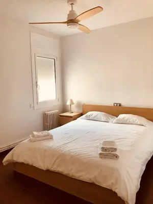 a bedroom with a bed with two towels on it at Sant Guillem in Vilassar de Mar