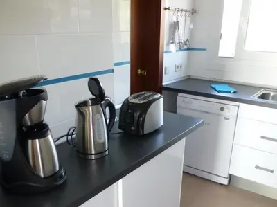 a kitchen with a counter top with pots and pans at Apartment La Rosa (Blaumar) in Sant Andreu de Llavaneres