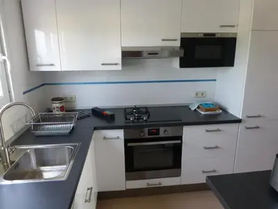 a kitchen with a sink and a stove top oven at Apartment La Rosa (Blaumar) in Sant Andreu de Llavaneres