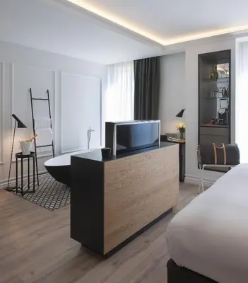 a hotel room with a bed and a television at Serras Barcelona in Barcelona