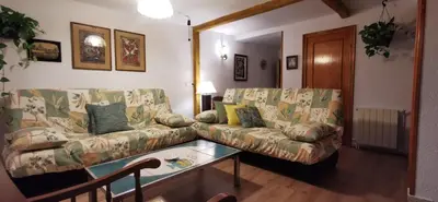 a living room with a couch and a coffee table at Joanet Guarda turismo familiar en plena naturaleza in La Guardiola