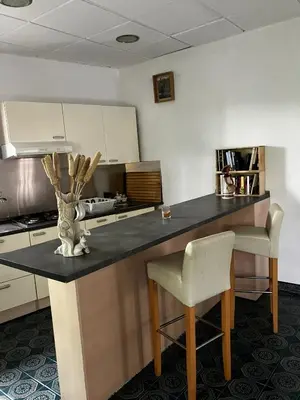 a kitchen with a counter with a table and chairs at Loft Rural Barcelona in Barcelona