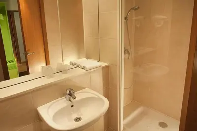 a bathroom with a sink and a shower at Travelodge BCN Cornella Fira in Cornellà de Llobregat