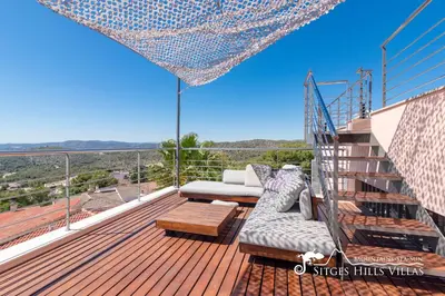 a table and chairs on a patio with a grill at Stylish Villa Havana with Sea Views, Private Pool & A/C in Sitges