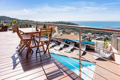 a view of a city from a balcony of a building at Stylish Villa Havana with Sea Views, Private Pool & A/C in Sitges