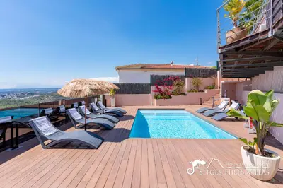 a bathroom with a toilet and a sink and a window at Stylish Villa Havana with Sea Views, Private Pool & A/C in Sitges