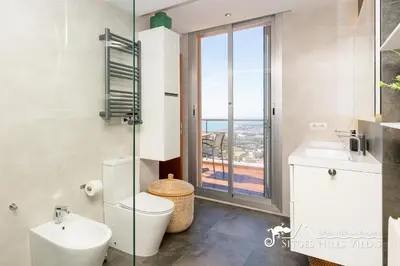 a staircase in a home with a large window at Stylish Villa Havana with Sea Views, Private Pool & A/C in Sitges