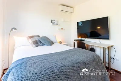 a bedroom with a bed and a large window at Stylish Villa Havana with Sea Views, Private Pool & A/C in Sitges