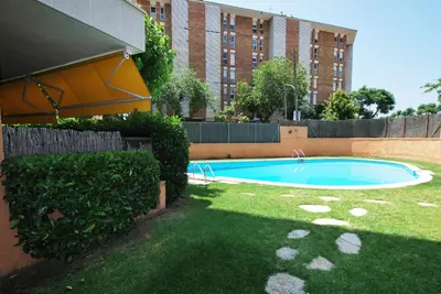 a swimming pool in a yard next to a building at Narciso views in Vilassar de Mar