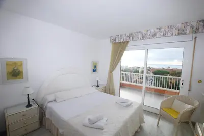 a bedroom with a bed and a window with a balcony at Narciso views in Vilassar de Mar
